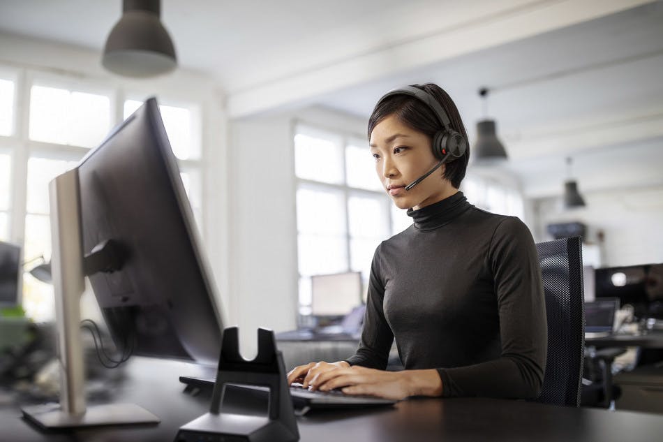 Woman with Headset at Computer