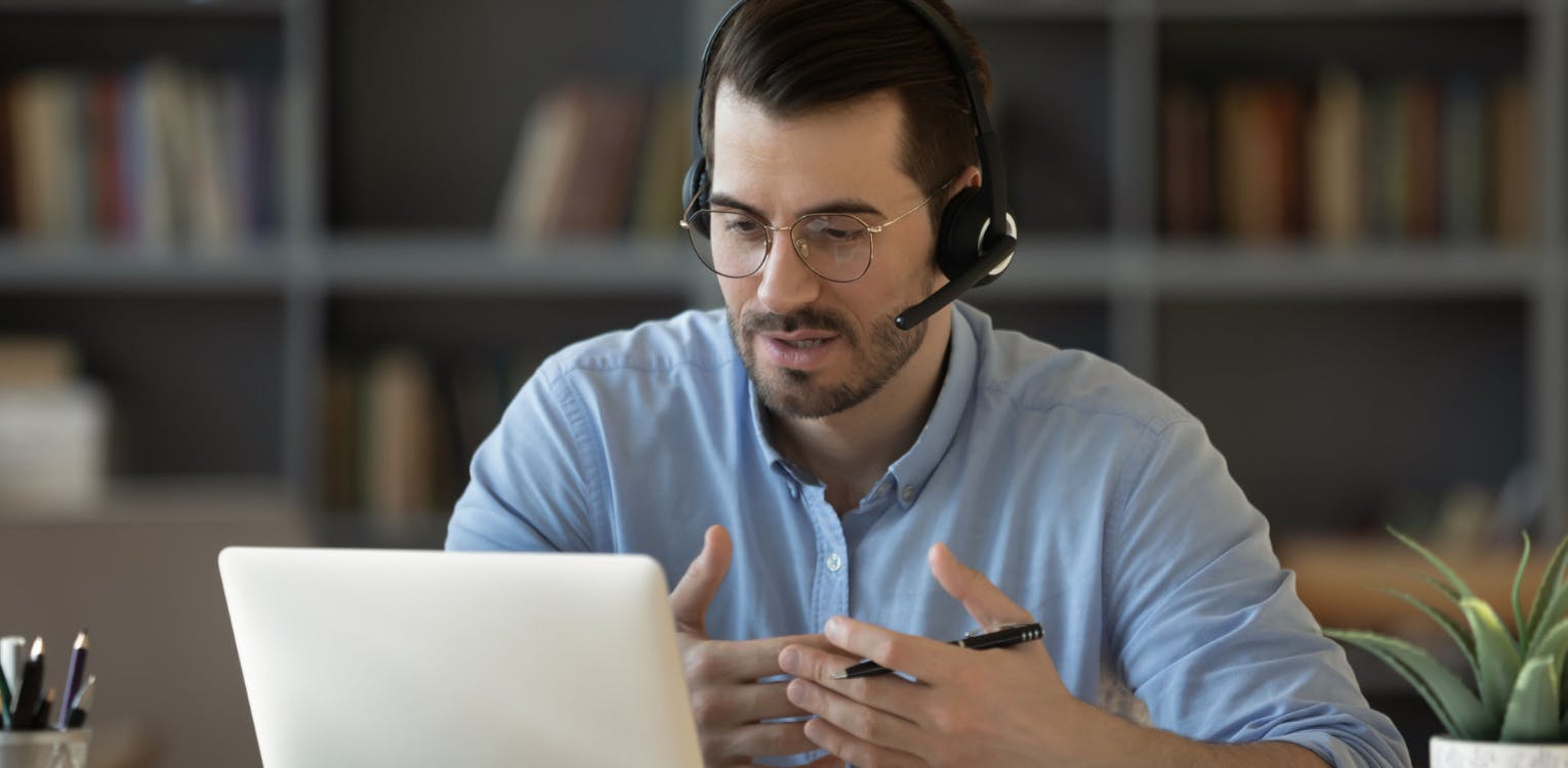 Man with Headset Looking at Screen