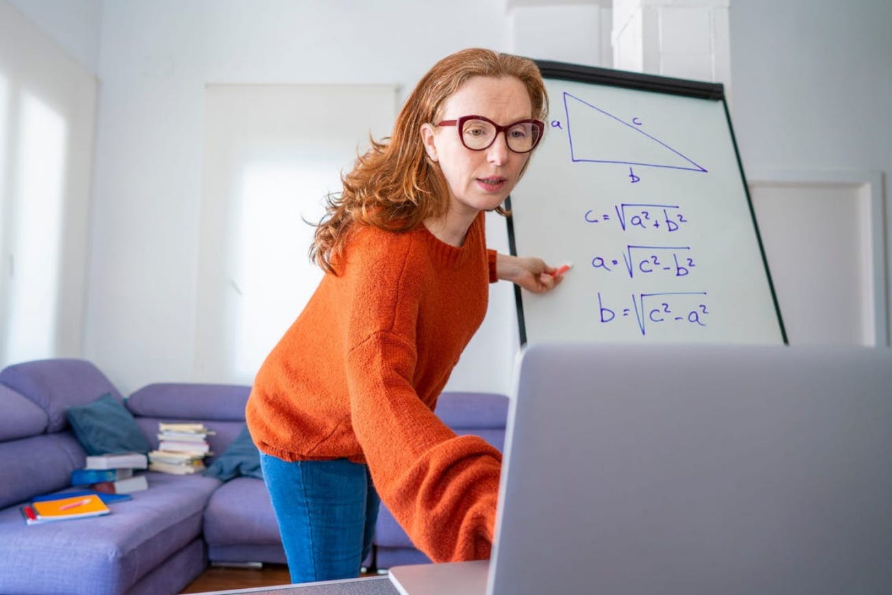 Woman Videoing Math on Whiteboard