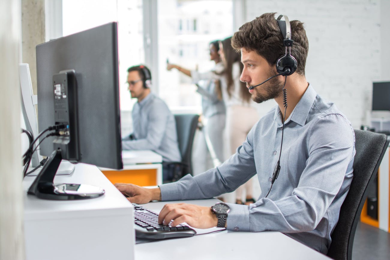 Man with Headset Using Computer