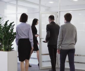 People Walking into Office